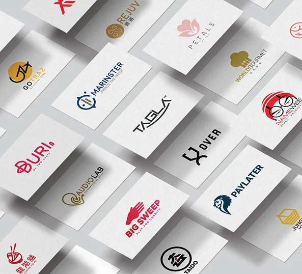 Designer sketching a logo mark and brand identity concepts at a studio desk